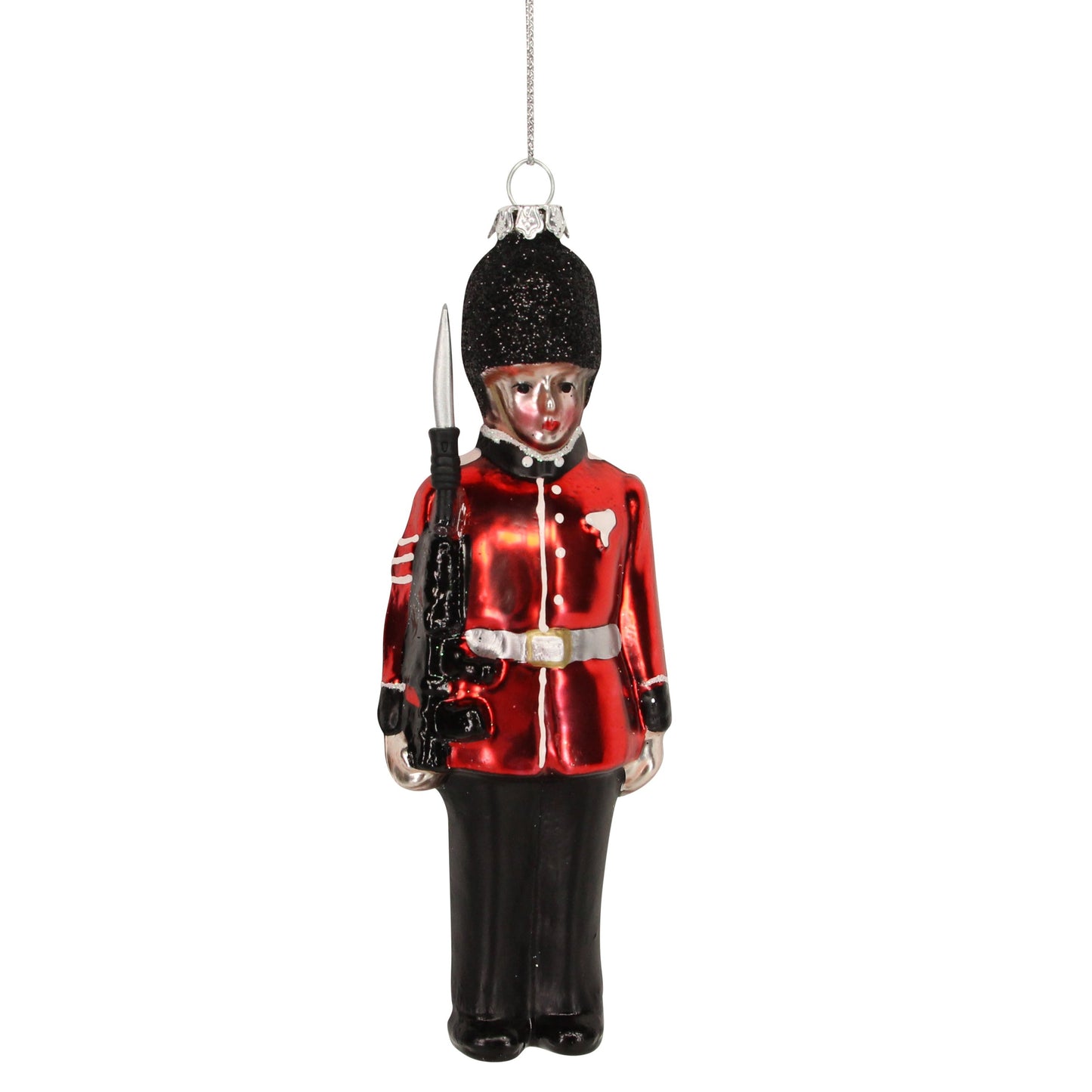 A glass hanging decoration featuring a painted soldier in a red coat and black pants, holding a black gun, with a silver-colored hat and belt buckle.
