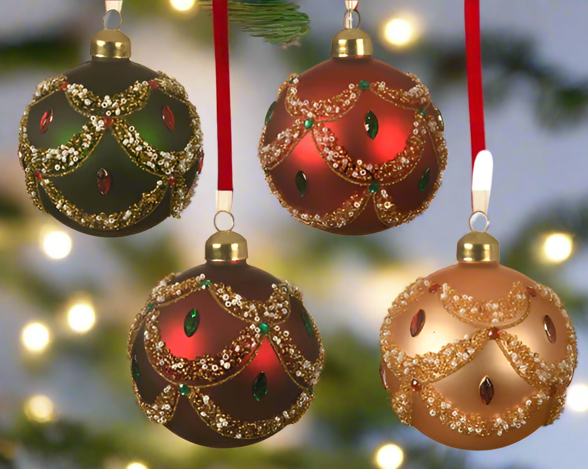 Set of four ornate Christmas ornaments in green, red, and gold on a white background.