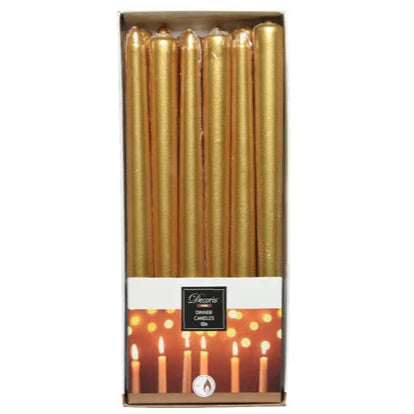 A pack of 12 metallic gold wax dinner candles presented in a box with a visual of lit candles in the background.
