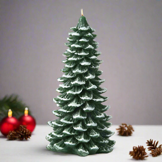 Christmas tree-shaped candle with red ornaments and pine cones on a gray background