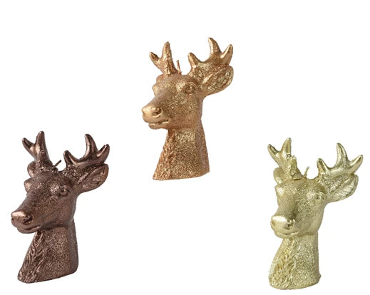 Three metallic deer head candles on a white background