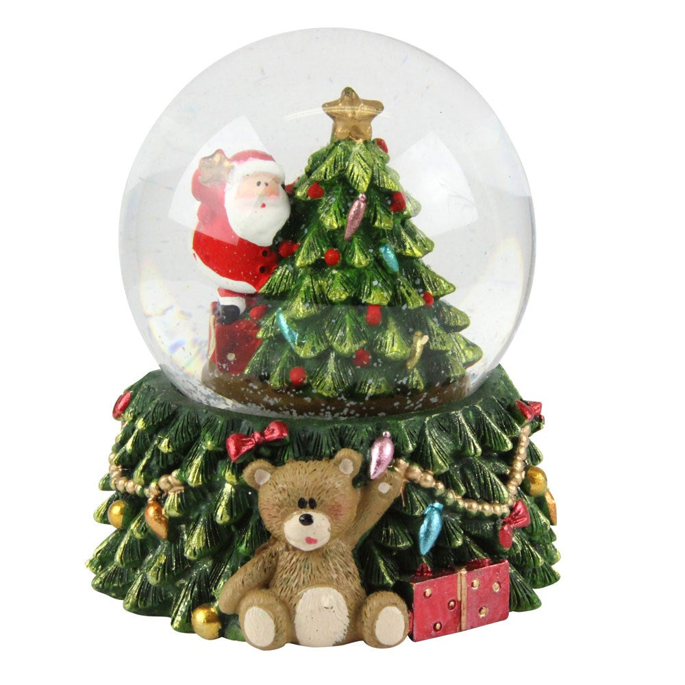 Christmas-themed snow globe with Santa Claus, tree, and teddy bear on a white background