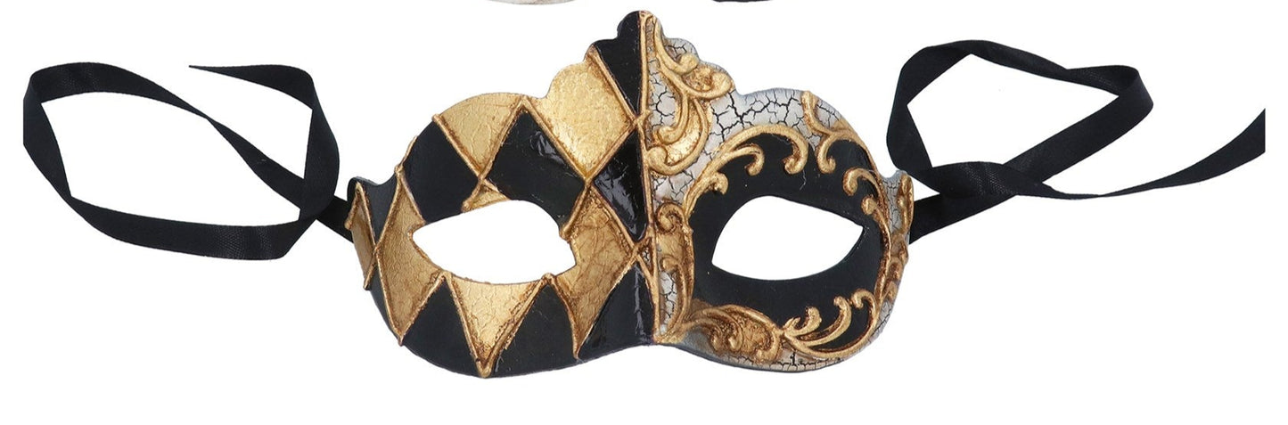 Decorative mask with black and gold design on a white background