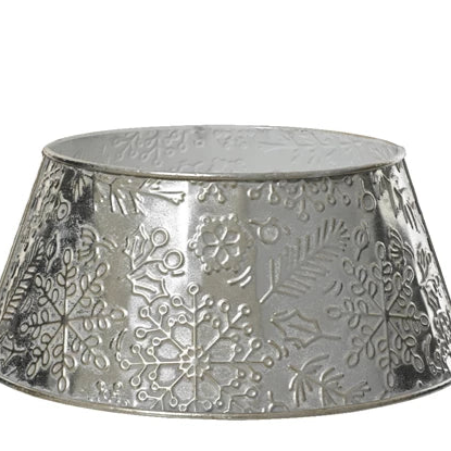 Decorative metal Christmas tree skirt with snowflake pattern on a white background