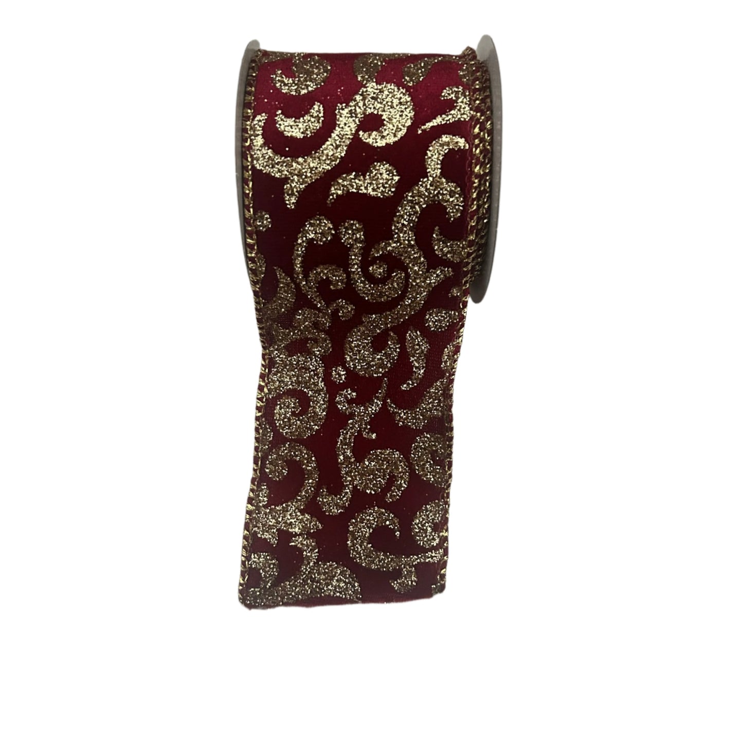 A roll of burgundy and gold velvet Christmas ribbon with a glitter pattern, displayed on a red cardboard core.