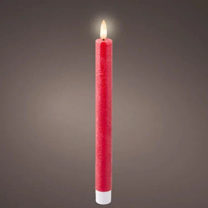 A single red flat top LED wax dinner candle with a warm white glow, standing upright against a grey background.