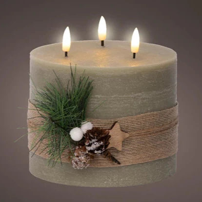 A green LED 3-wick wax candle with foliage decoration, including a pinecone and a burlap ribbon, with three warm white LEDs on top.