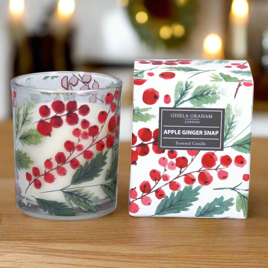 A glass paraffin wax candle with a red berry design and 'Apple Ginger Snap' scent, accompanied by its packaging box with a matching design.