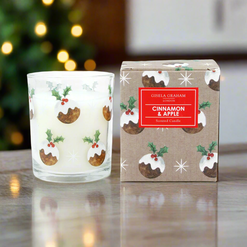 A glass jar candle with a Christmas pudding design, featuring cinnamon and apples fragrance, wrapped in festive Christmas puddings patterned paper.
