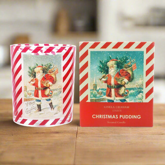 A Christmas-themed candle with a Santa design, striped red and white packaging, and a Christmas pudding scent.