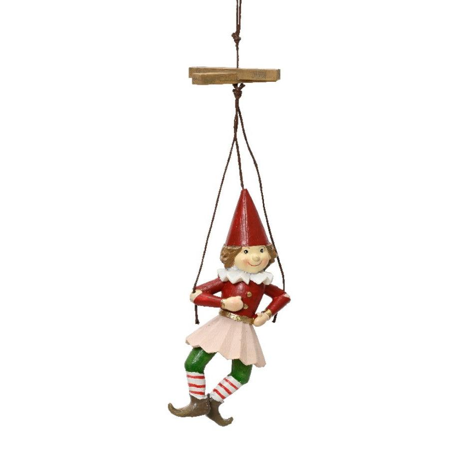 A hanging puppet-style doll dressed in red and green with white stockings and red hat, designed as a Christmas decoration.