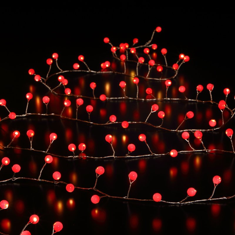 A string of red LED Christmas lights designed to resemble snowberries on a copper wire.