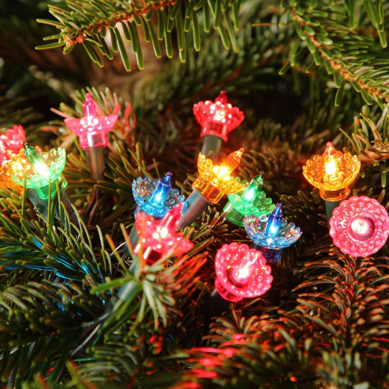 Vintage style Christmas tree lights with a green cable, featuring multicolored LED bulbs displayed on a Christmas tree.