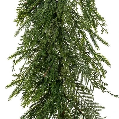 A faux green Christmas garland with mixed foliage, designed for indoor use.