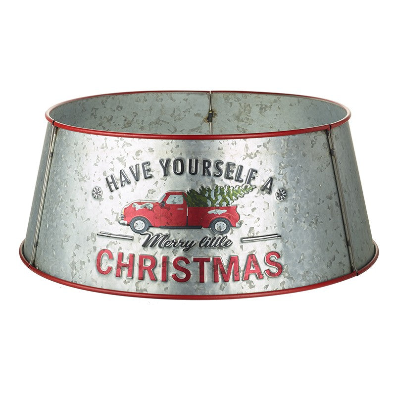 Silver metal tree skirt with red trim on the top and bottom. Image of a red truck with a tree in the trunk, with the wording Have Yourself A Merry little Christmas written across.