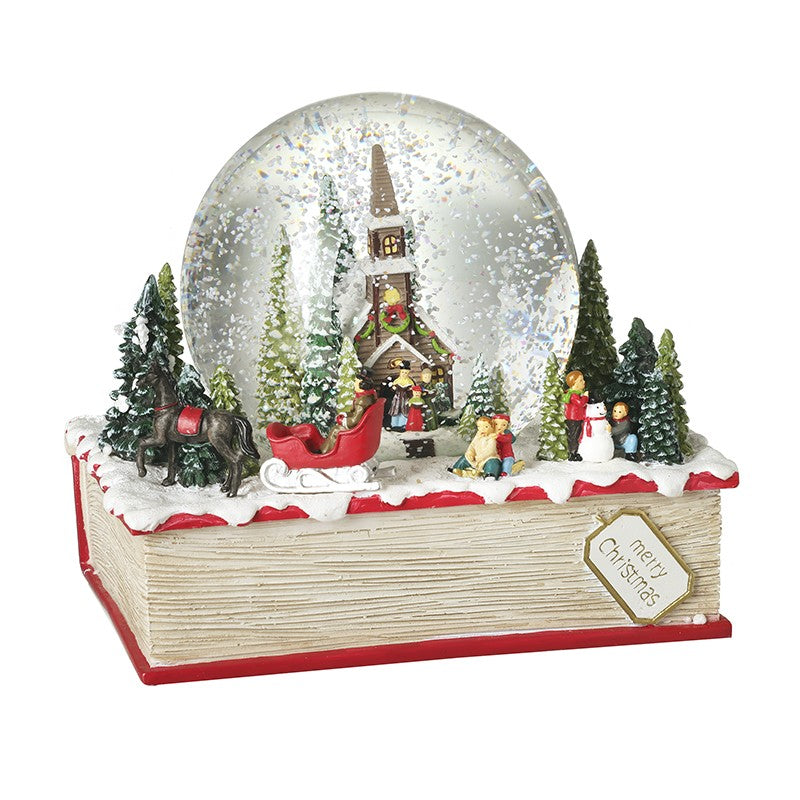 Christmas Church Scene Snow Globe on a Book