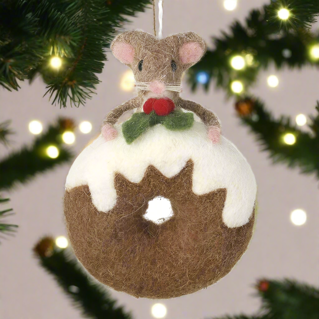 A felt ornament in the shape of a mouse sitting on a donut with white icing, decorated with a green and red detail on the mouse's hat.