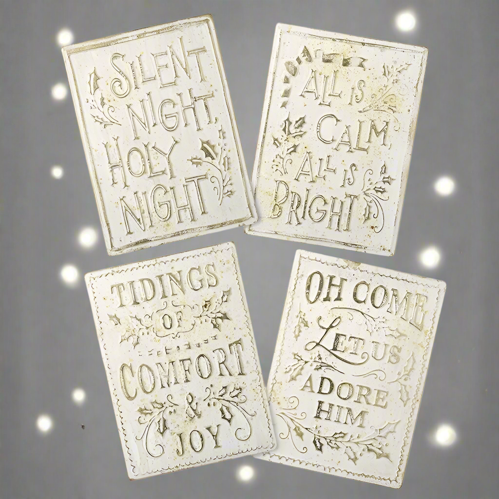 A set of four cream and gold aged effect Christmas signs with different texts, including 'Silent Night', 'All is Calm', 'Tidings of Comfort', and 'Oh Come Let us Adore Him'.