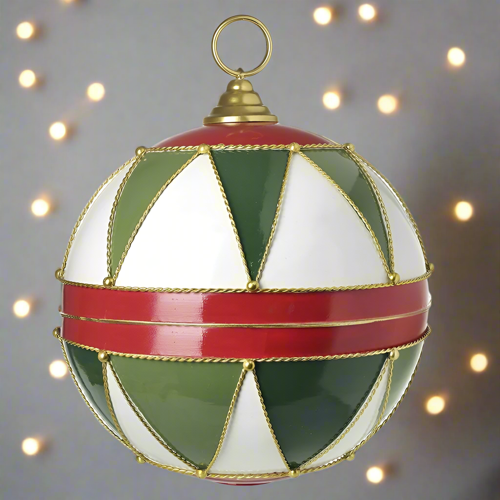A large hanging Christmas ornament with a geometric pattern in red, green, white, and gold colors.