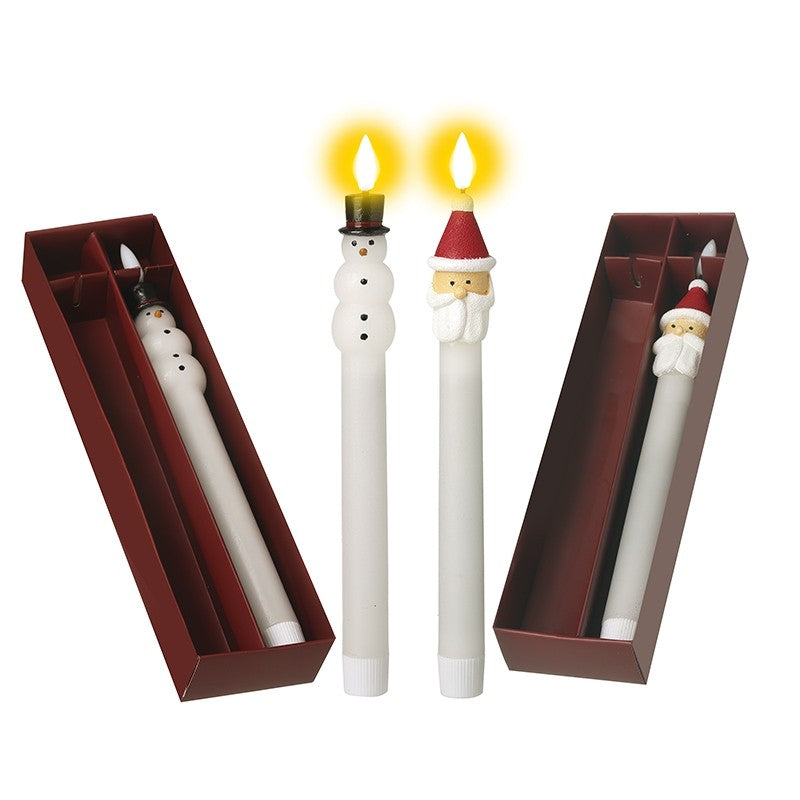 Two LED dinner candles designed to look like Santa and Snowman, with white bodies and decorative features, displayed in red packaging.