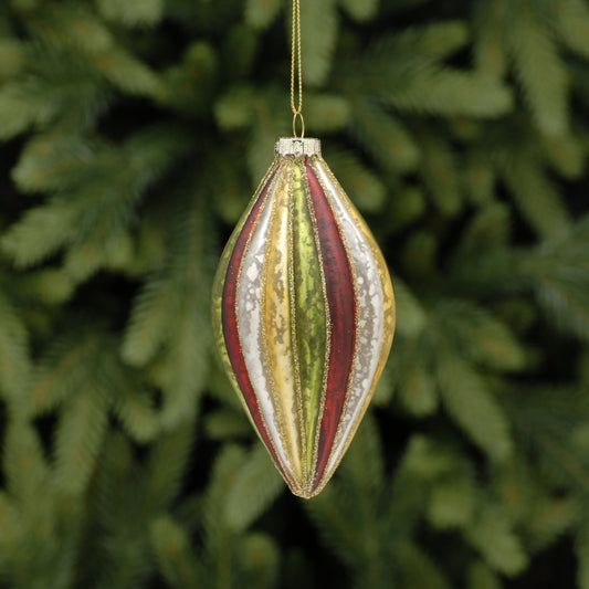 A vintage style glass bauble with red, gold, and green stripes, hanging from a wire against a blurred green pine background.