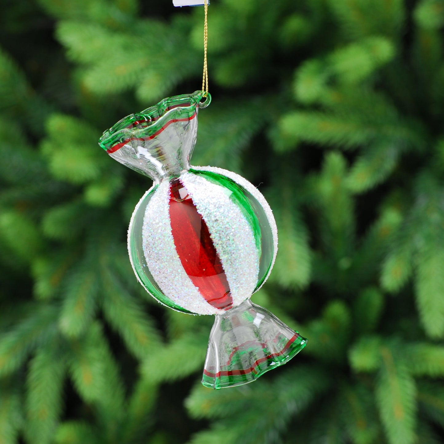 A striped sweet glass hanging decoration with red and white stripes, clear glass, gold hanging wire, and white candy-shaped ornament.