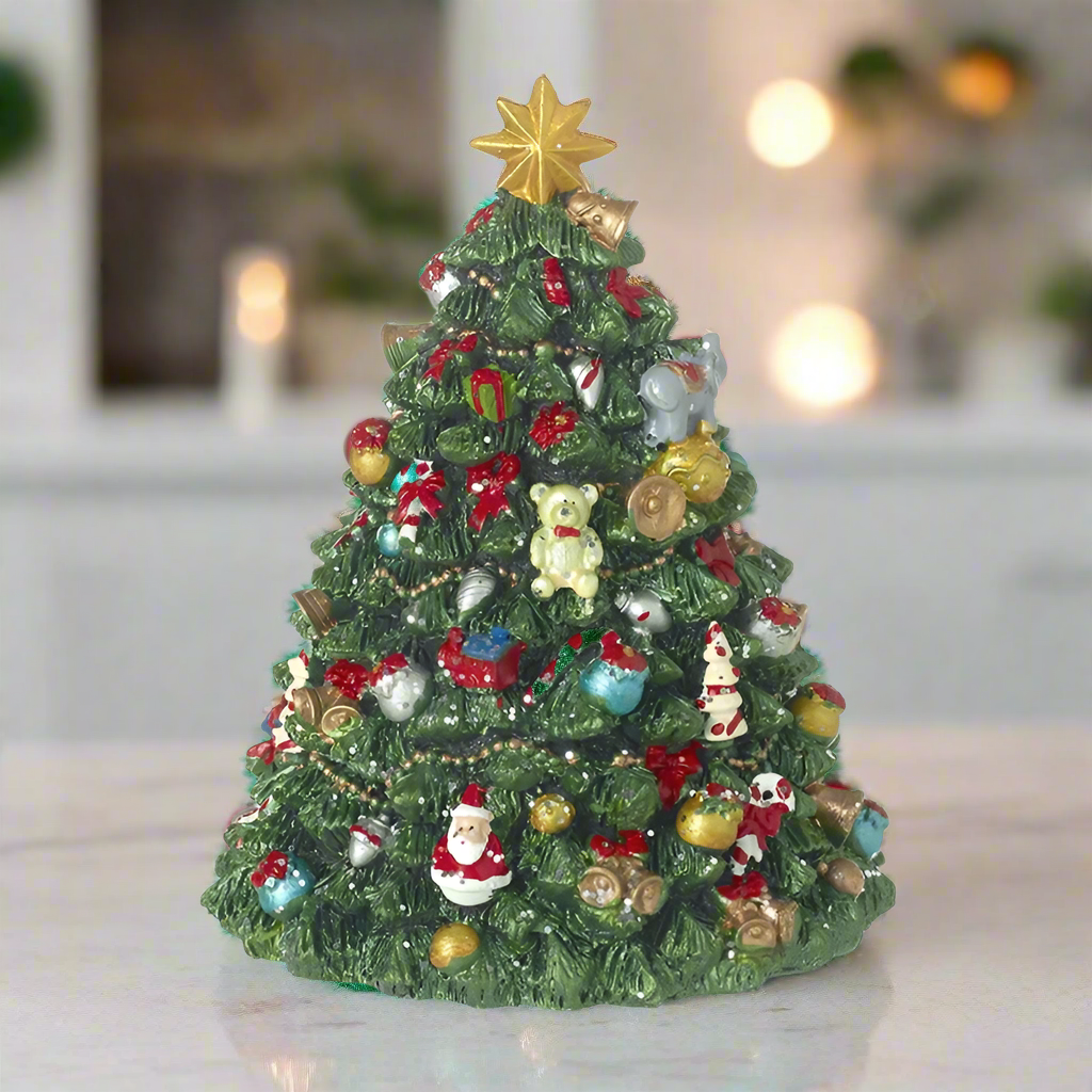 A music box depicting a rotating Christmas tree with ornaments and a golden star on top, set against a warm background with candles.
