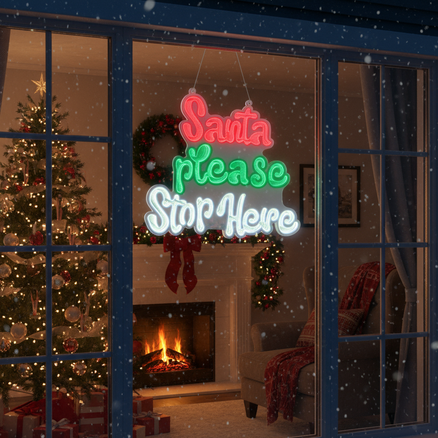 Neon sign reading 'Santa Please Stop Here' in a festive living room with Christmas decorations.