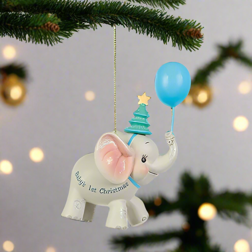 A hanging Christmas decoration featuring an elephant in a Santa hat holding a blue balloon.