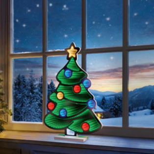 Decorative Christmas tree light on a windowsill with a snowy landscape outside