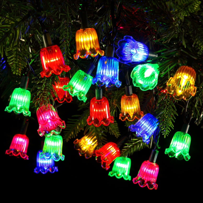 A string of multicolored battery-operated Christmas lights displayed on a tree.