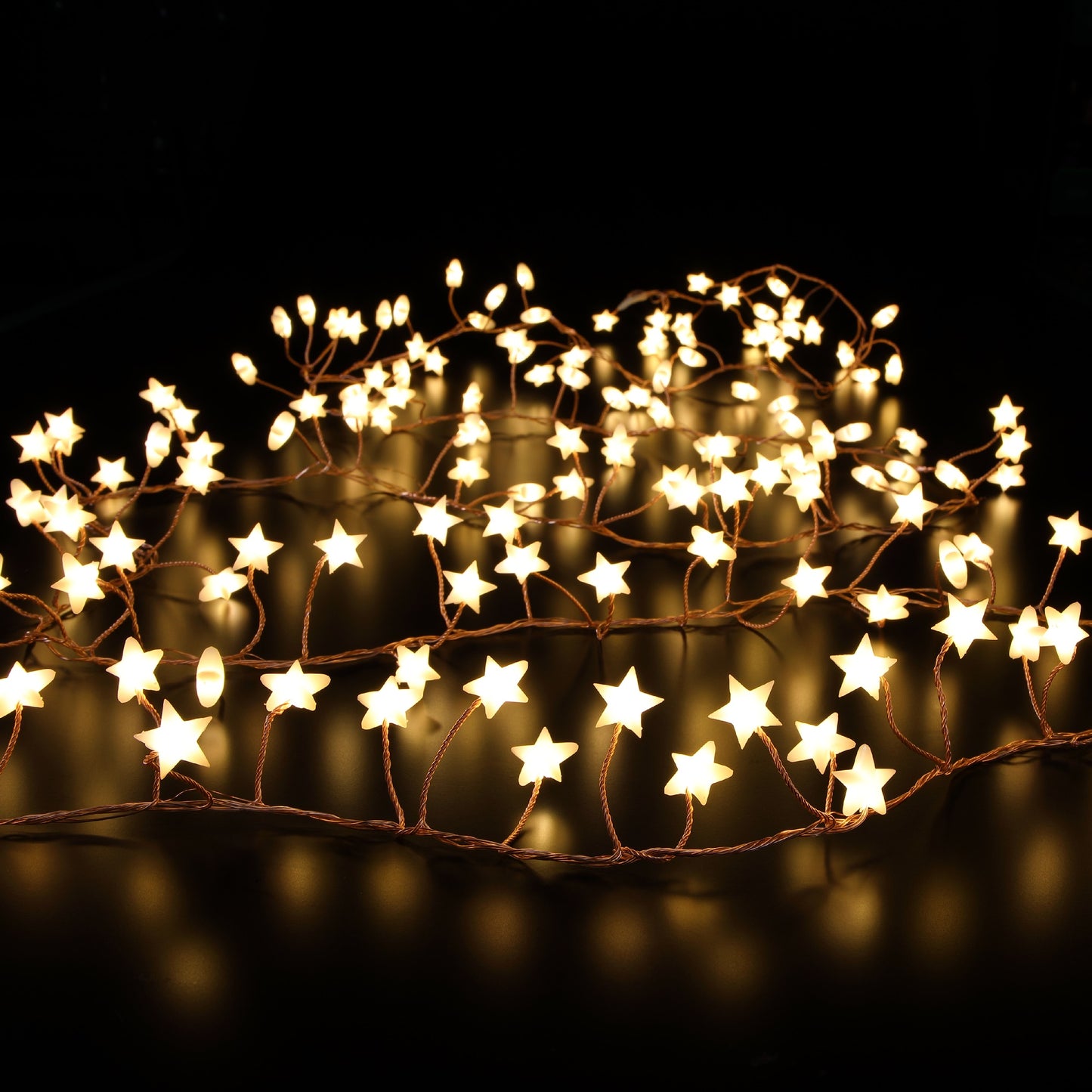 A garland of frosted star-shaped LED lights glowing in a warm white color, displayed against a dark background.