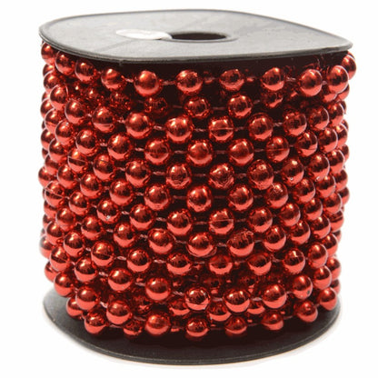 A spool of shiny red bead garland.