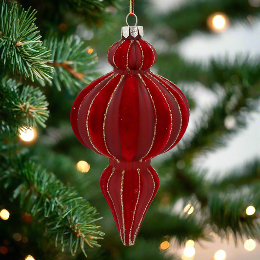 Red glass ornament with gold stripes on a white background