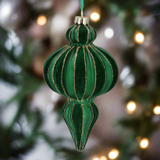 Green glass ornament with gold stripes on a white background