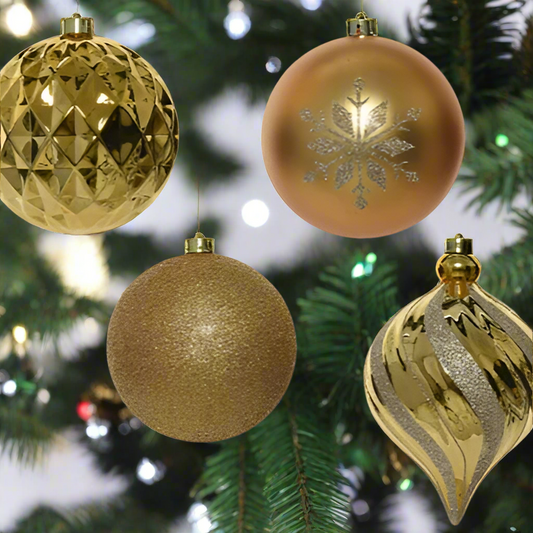 Four gold Christmas ornaments with different designs on a white background