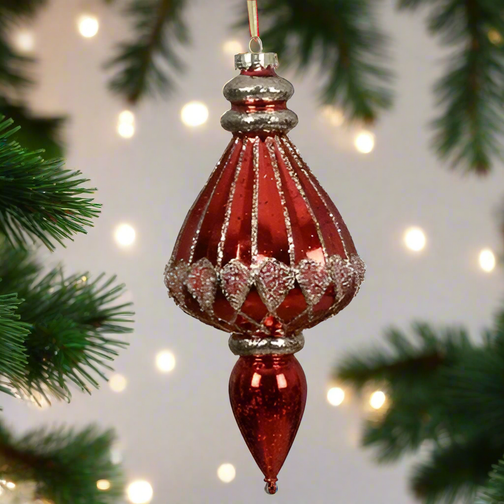 An oversized red finial style Christmas hanging decoration with golden glitter and a gold hanging ribbon.