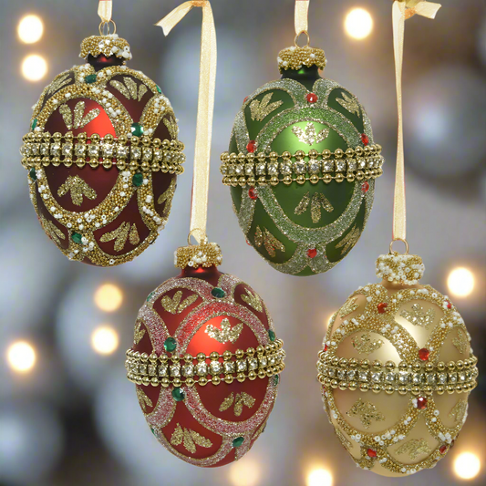 Decorative Christmas ornaments shaped like eggs in red, green, and gold on a white background.