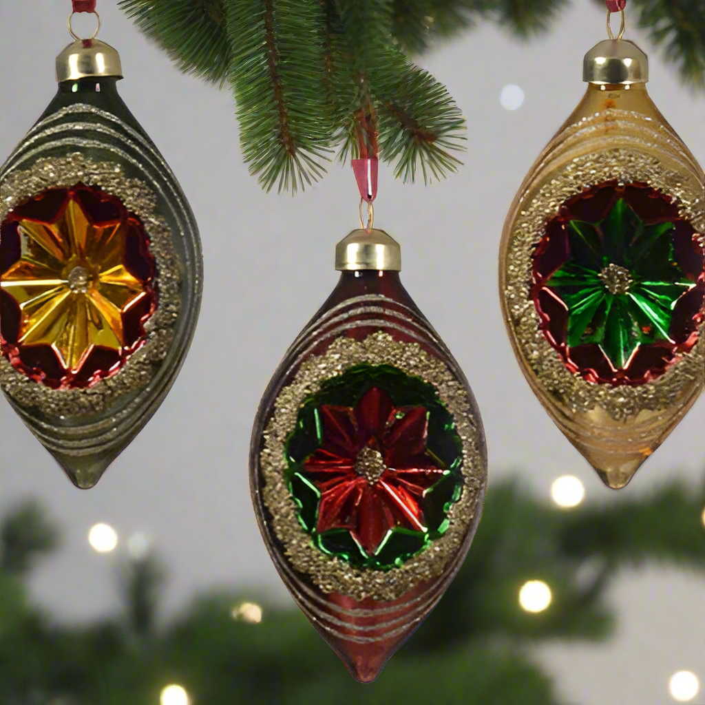 Three decorative Christmas ornaments with floral designs on a white background