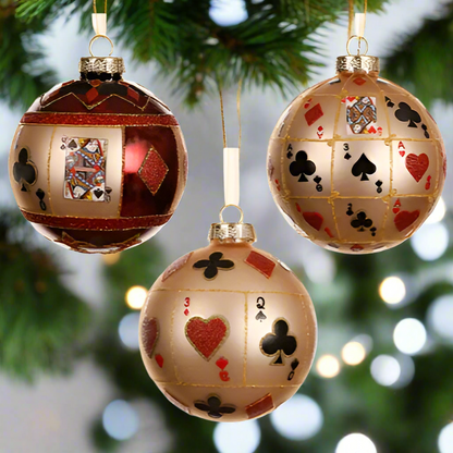 Three decorative Christmas ornaments with playing card designs on a white background