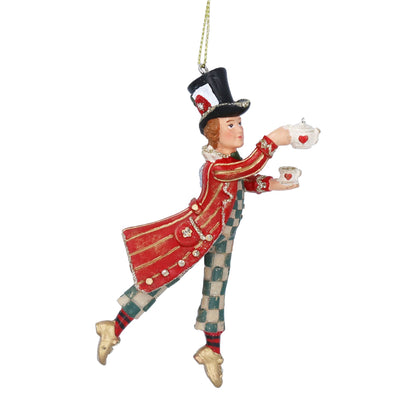 Decorative ornament of a man in a red outfit with a top hat, holding teacups on a white background.