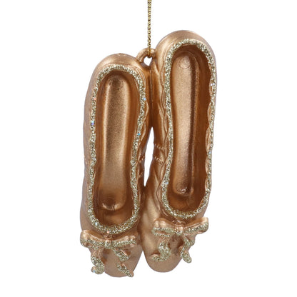 Decorative rose gold ballet shoes ornament on a white background