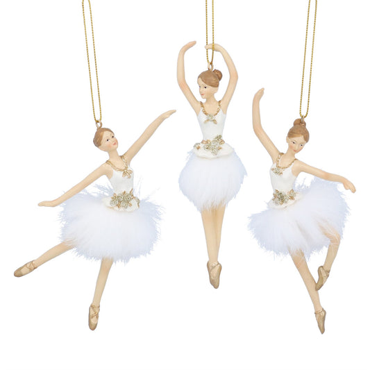 Three ballerina figurines in white tutus with gold accents on a white background