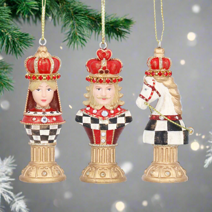 Three decorative chess piece ornaments with crowns on a white background