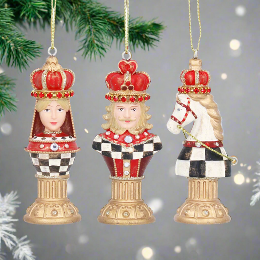 Three decorative chess piece ornaments with crowns on a white background