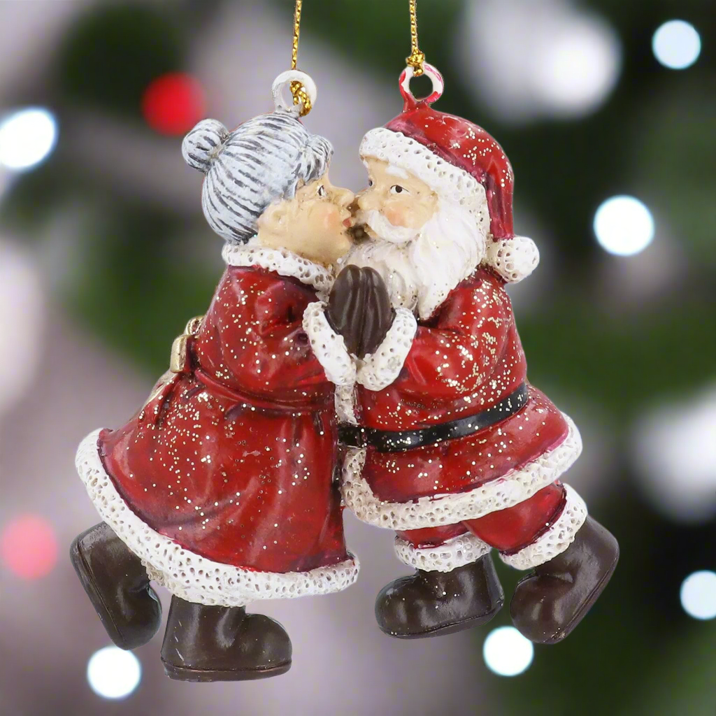 Decorative Christmas ornament of a kissing Santa Claus and Mrs. Claus on a white background