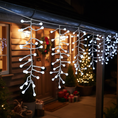 Strings of white LED icicle lights hanging from a distance, creating an icicle effect, against a dark background.