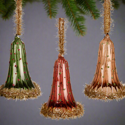 Three decorative cones with tinsel on a white background