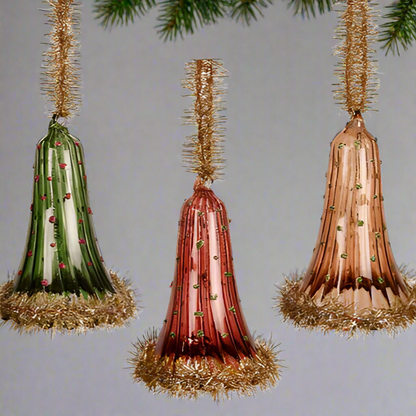Three decorative cones with tinsel on a white background
