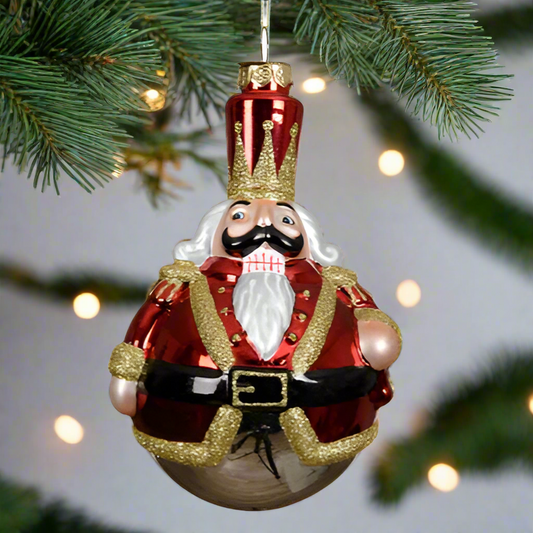 Decorative Christmas ornament of a king in red attire with a crown on a white background